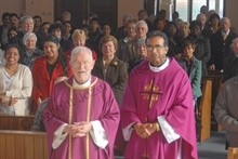 Father Harrington with Parishioners in church